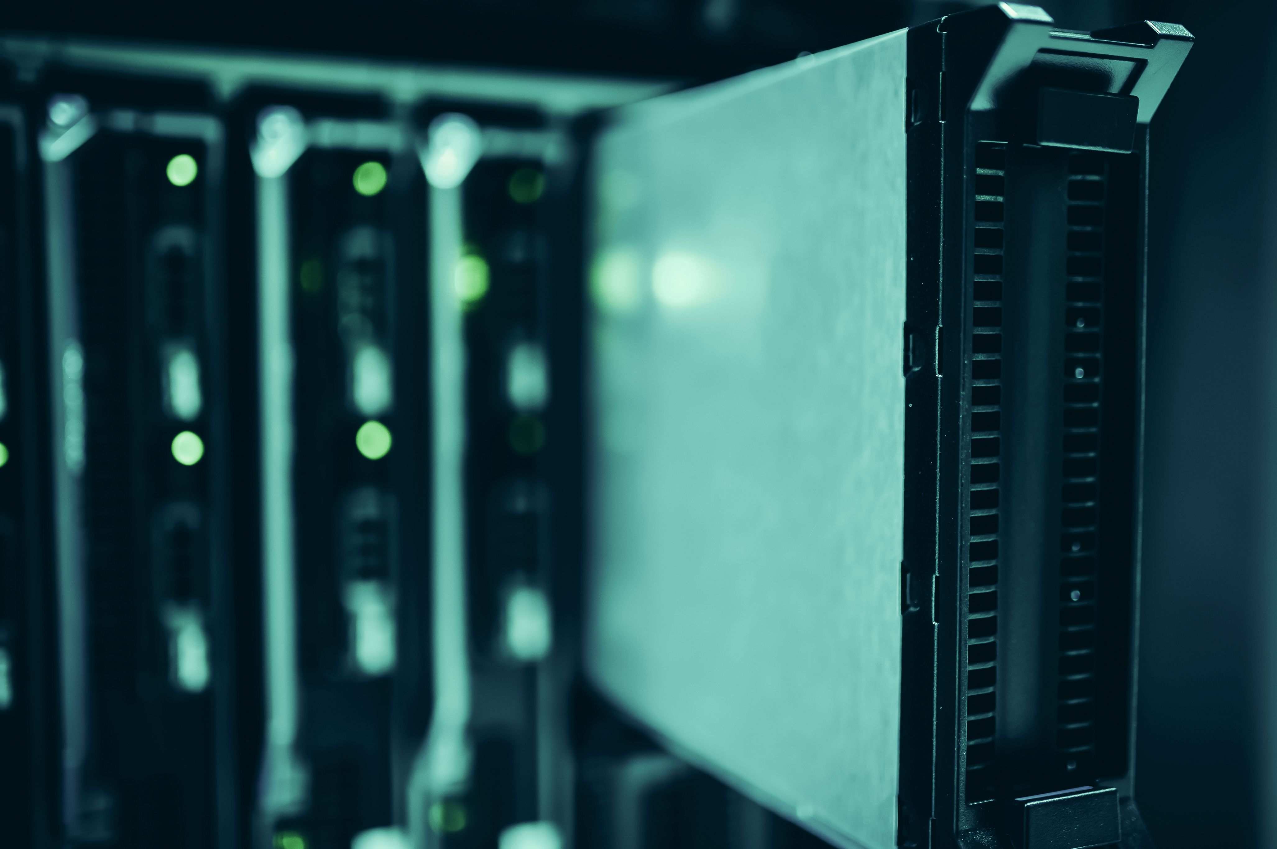Wide view of a data center server aisle, server racks in a data center highlighting modern technology infrastructure